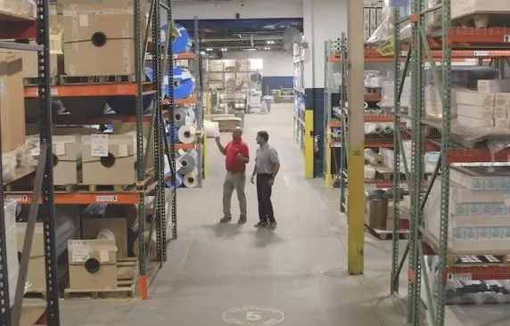 Two gentleman doing a warehouse walkthrough