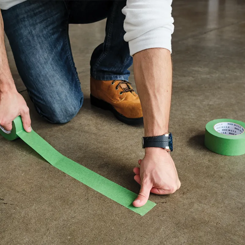 man using green painters tape